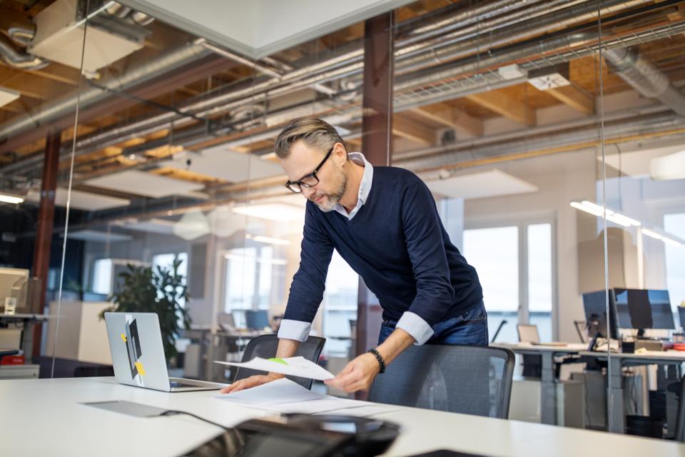 Businessman reviewing few reports in office