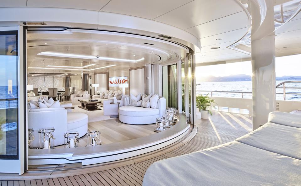 A stark-white living room and deck aboard superyacht New Secret.