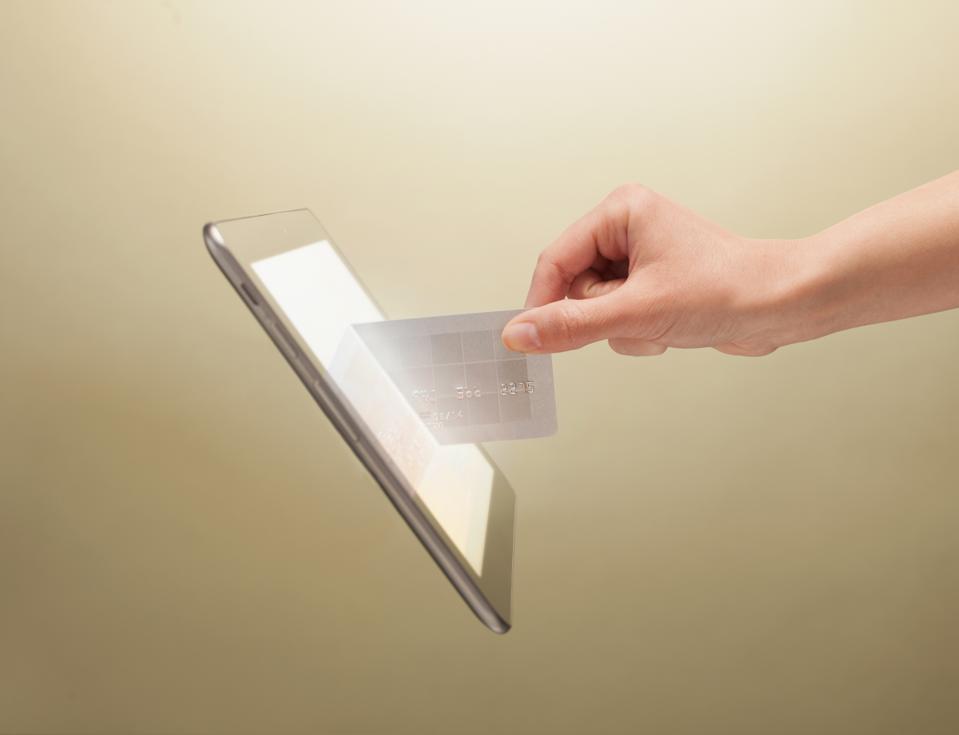 Hand placing credit card into tablet