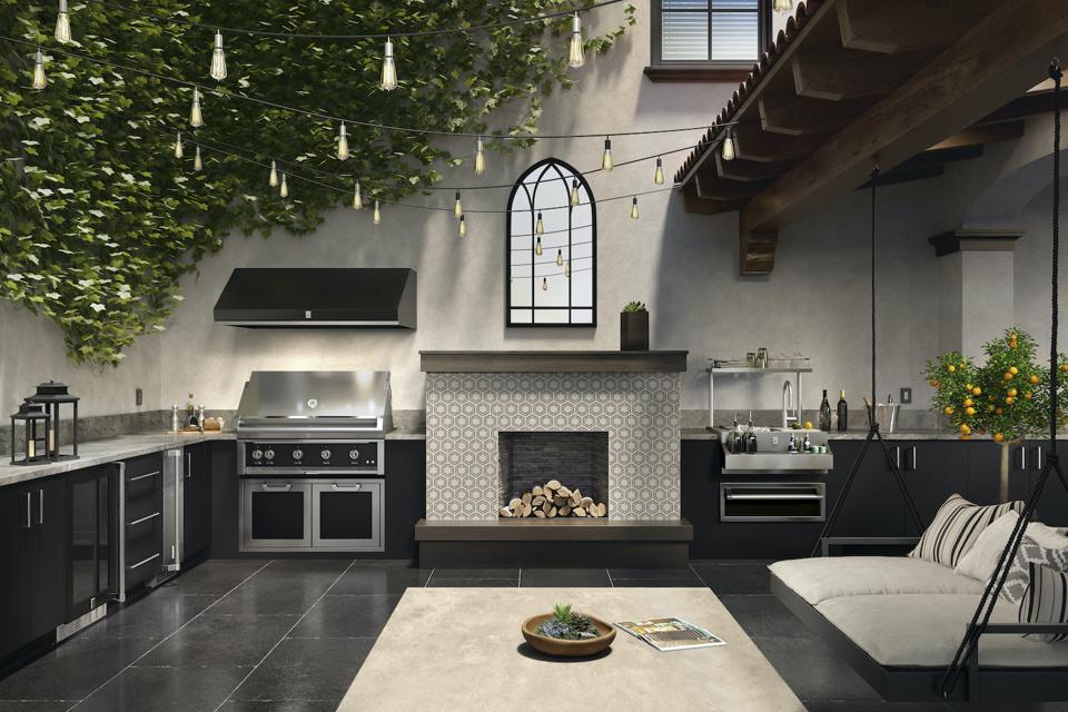 This full outdoor kitchen by Heston includes a grill, refrigerator, storage draws and a cool bar.