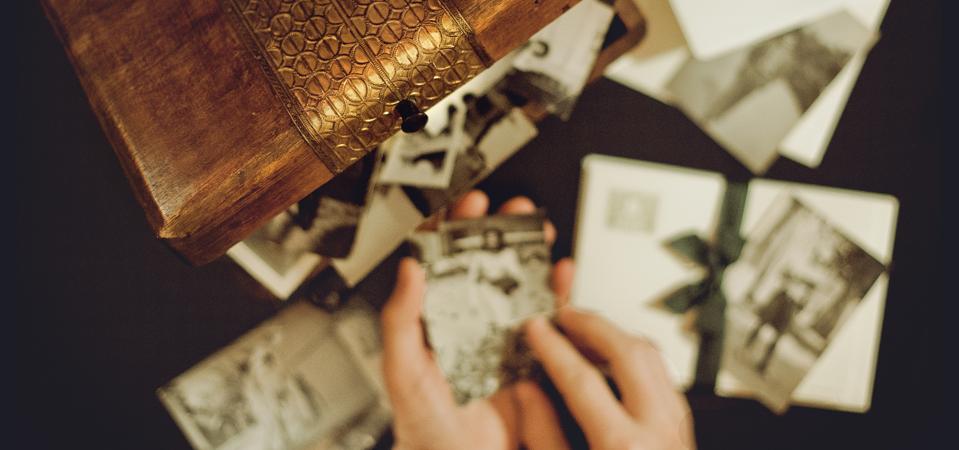Hands of man holding old photographs
