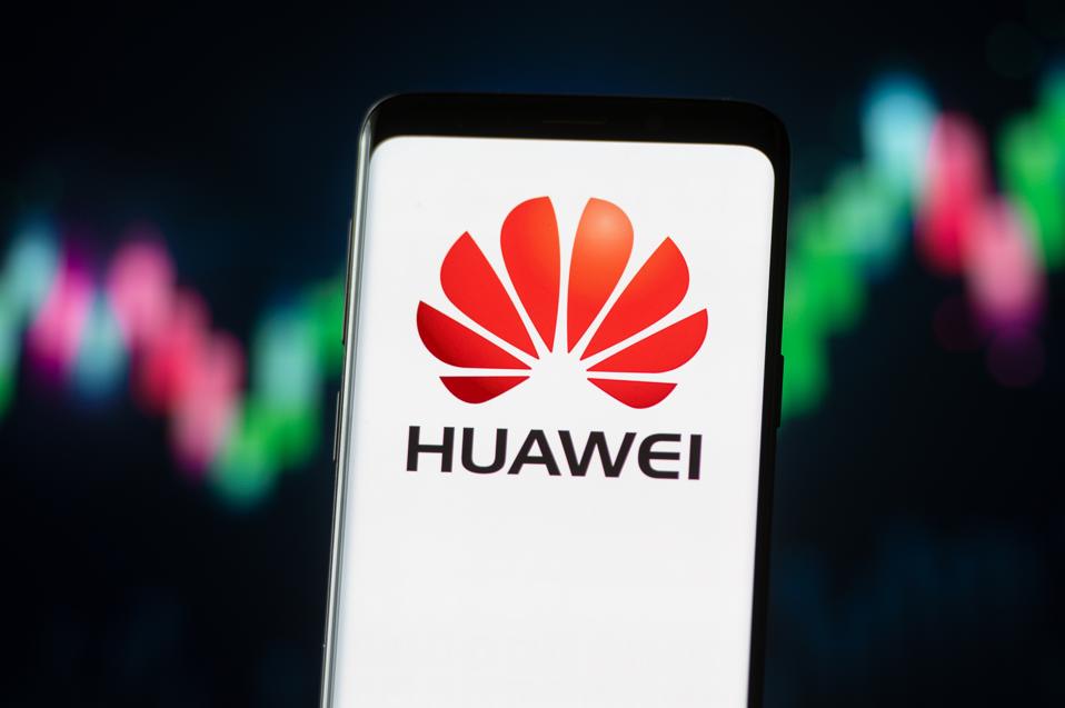 In this photo illustration a Huawei logo seen displayed on a...
