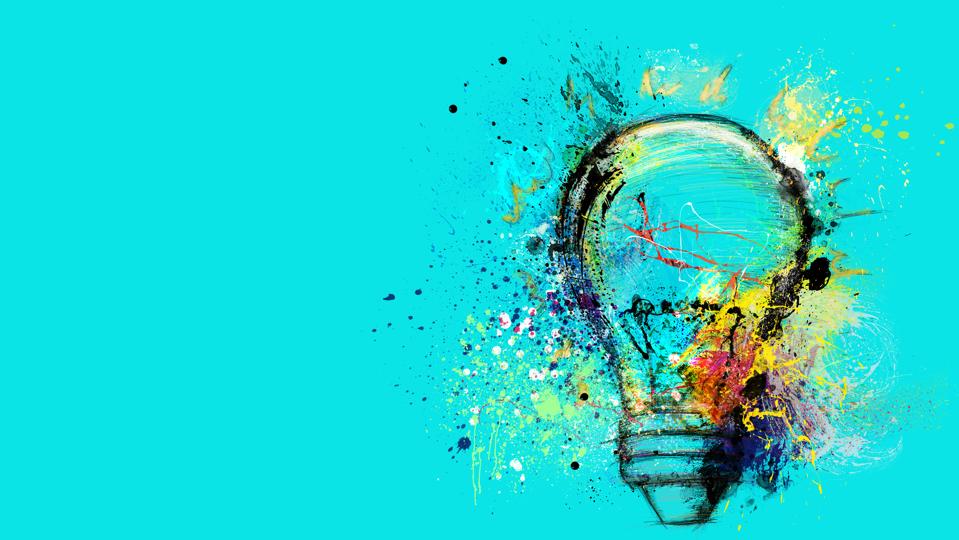 Large stylized light bulb on cyan background drawn with splashes of colorful paint. Concept of innovation and creative thinking