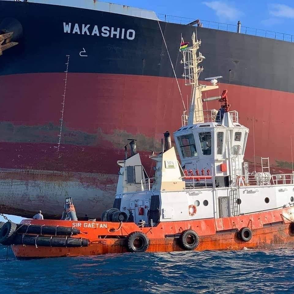 The Mauritius Port Authority tugboat, the Sir Gaetan supporting the salvage operations around the Wakashio, prior to the larger vessel splitting in two on August 15. The hull of the Wakashio can be seen clearly lifted in the air. 