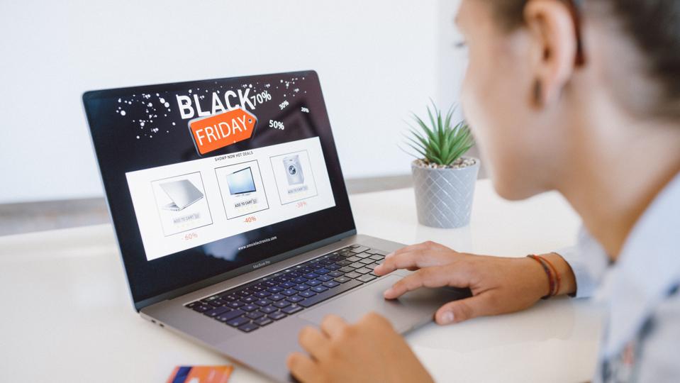 Woman Is Shopping Electronics Online for Black Friday deals.