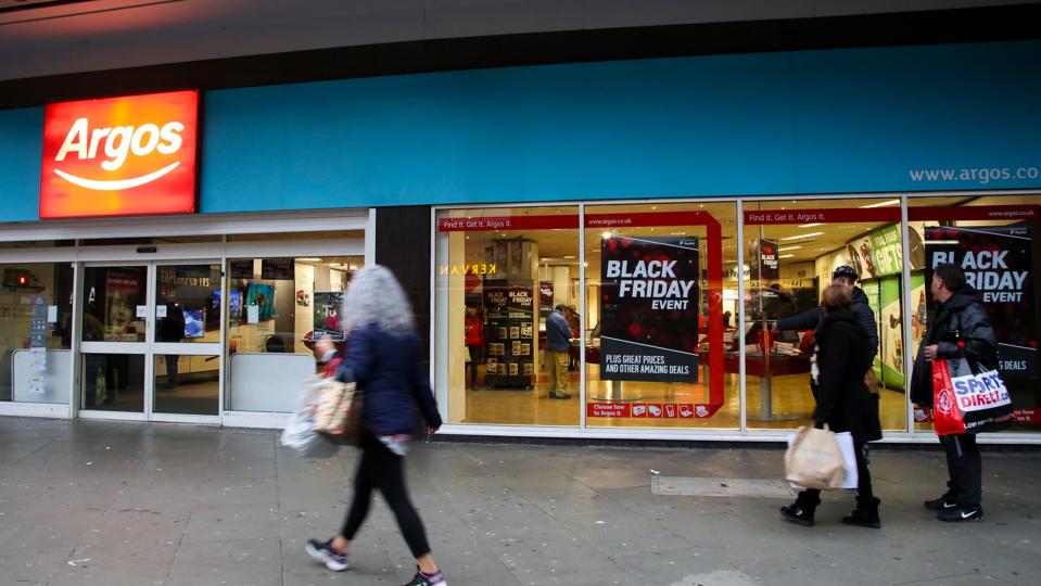 Shoppers are seen standing next to an Argos store in London.