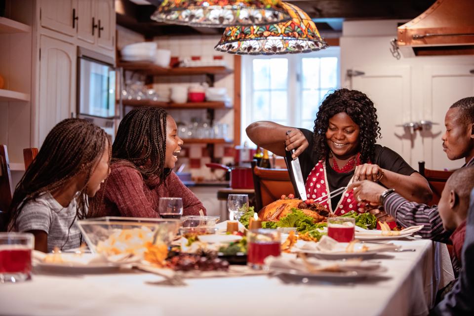 American-African family at table during thanksgiving dinner
