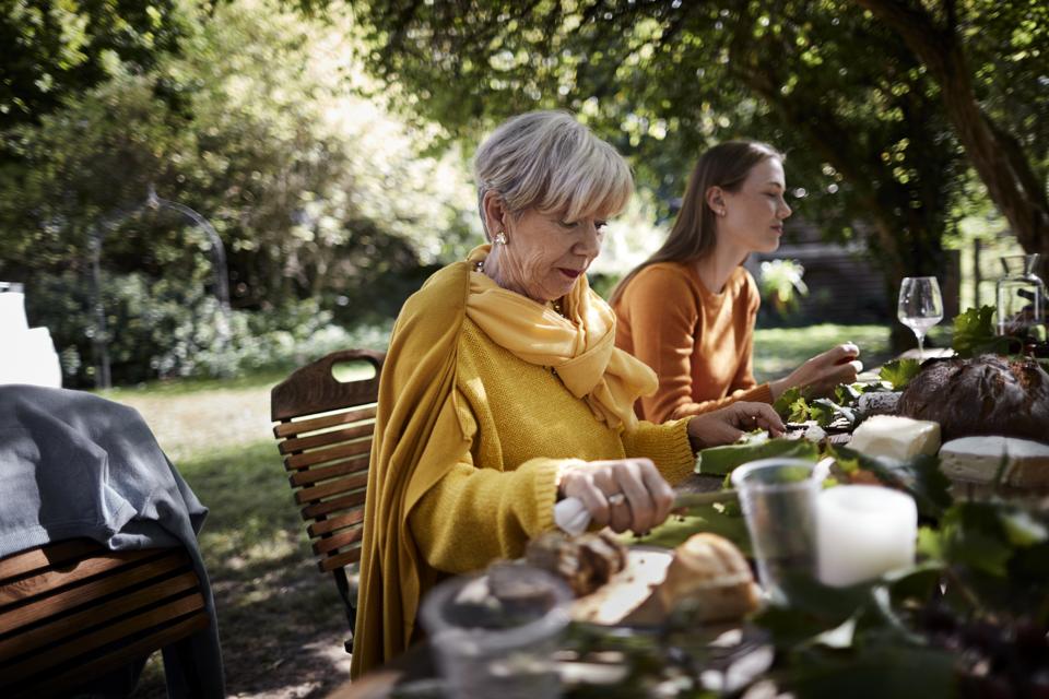 Senior woman and young woman dining al fresco
