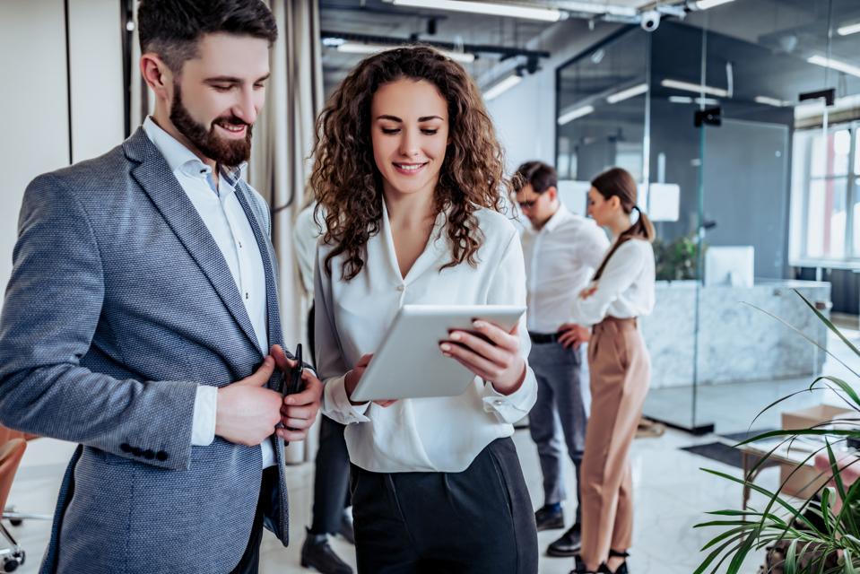 Business people having fun and chatting at workplace office
