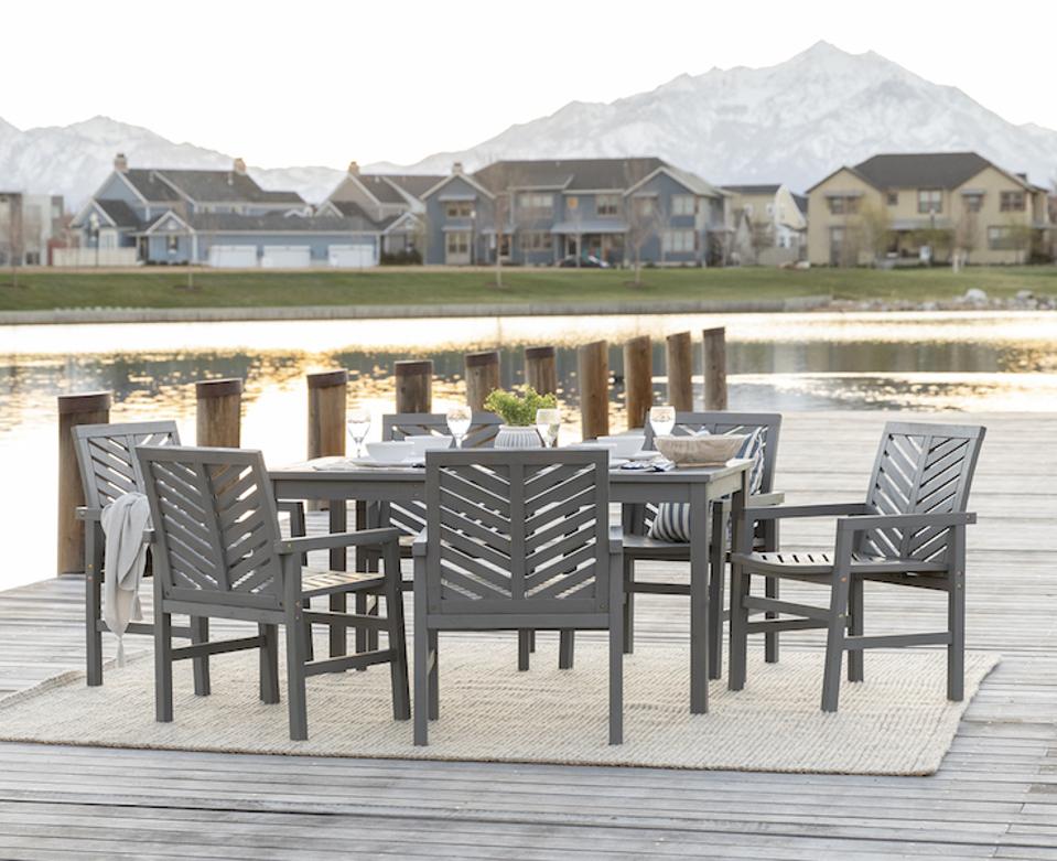 outdoor furniture by water with mountains in the background