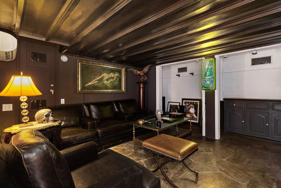 A subdued basement with black walls and ceilings.