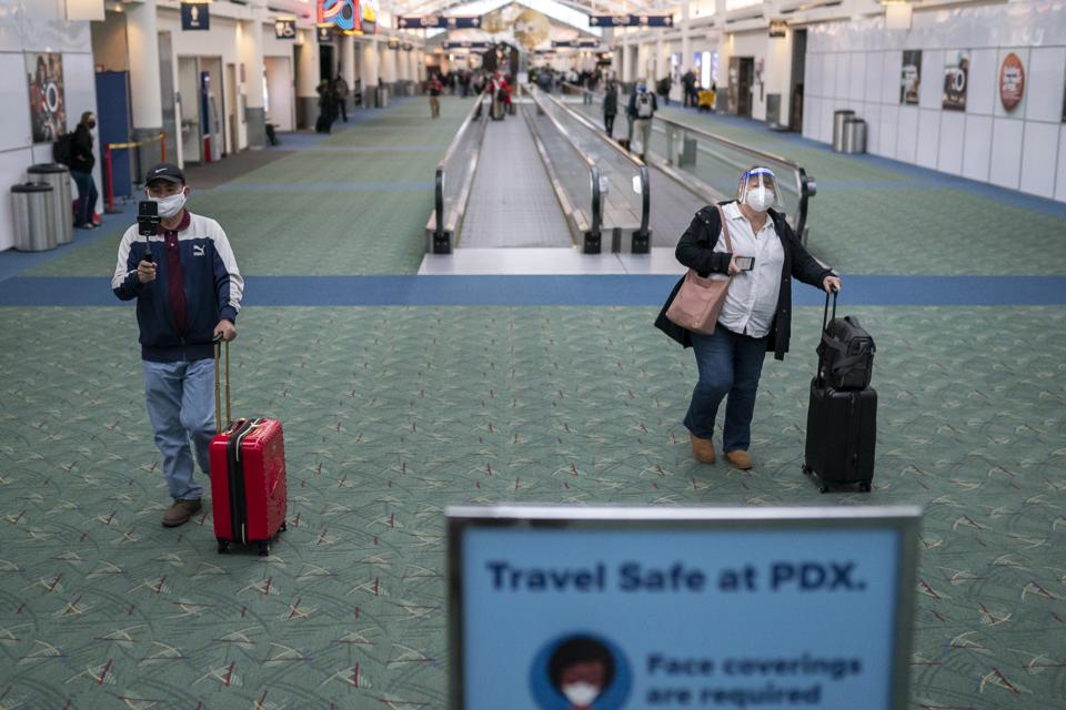 Travelers walk through Portland International Airport on November 25, 2020 in Portland, Oregon.