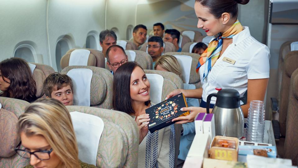 Cabin crew serving a passenger.