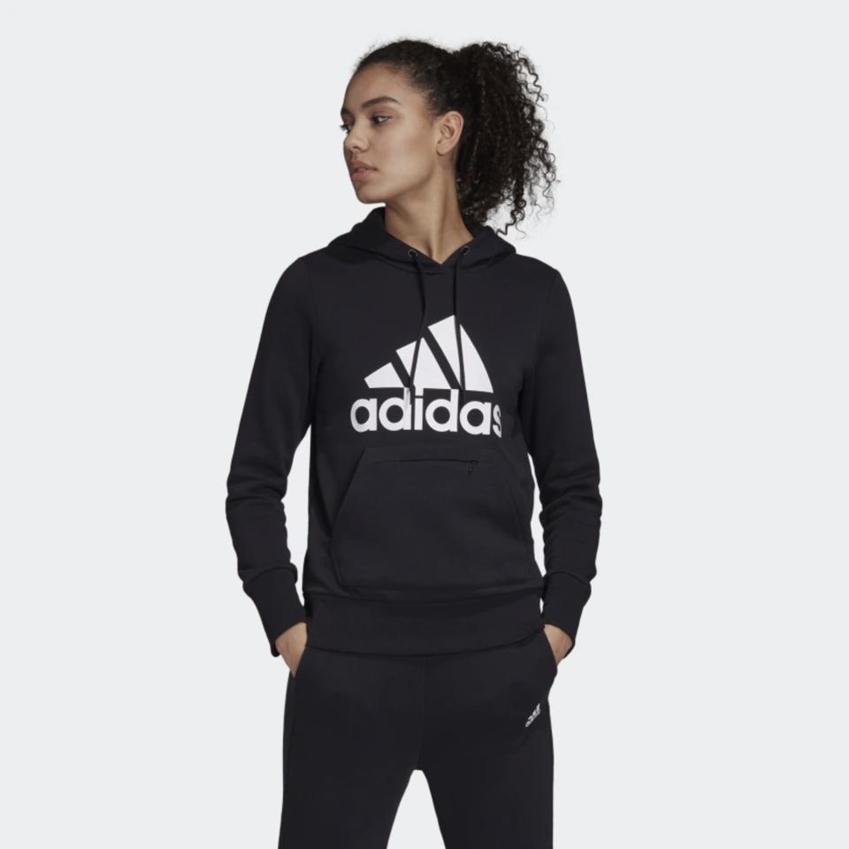 Woman wearing an Adidas Badge of Sport Pullover Fleece Hoodie