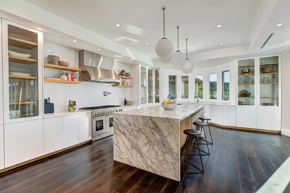 A kitchen with a center island and custom cabinetry.
