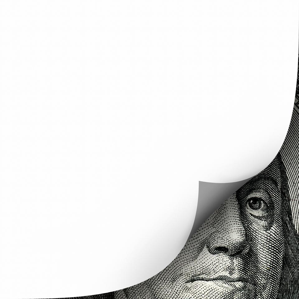 Conceptual finance image of white empty page curl over one hundred dollar bill of US currency