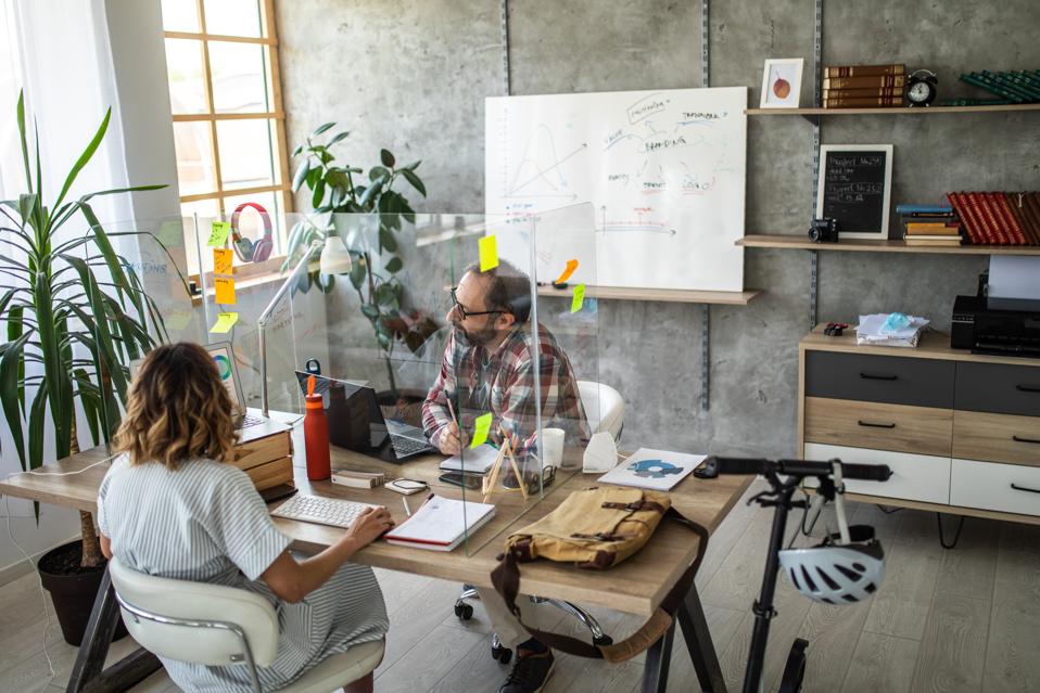 Colleagues discussing about business strategy at modern office