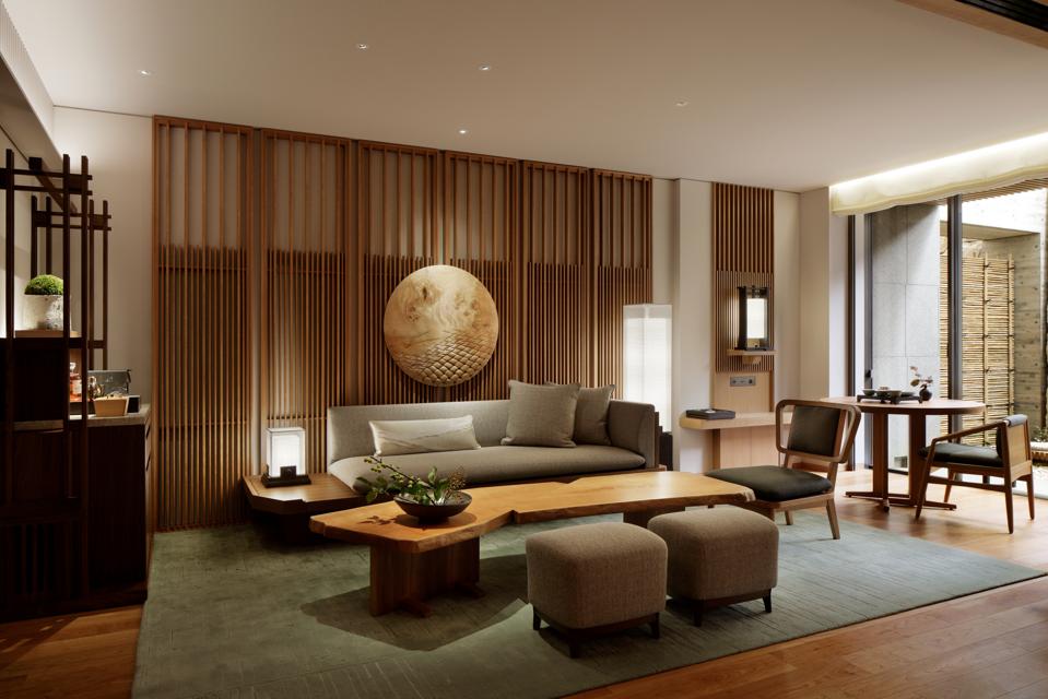 Sleek, contemporary furniture in beige and brown tones in a suite living room.