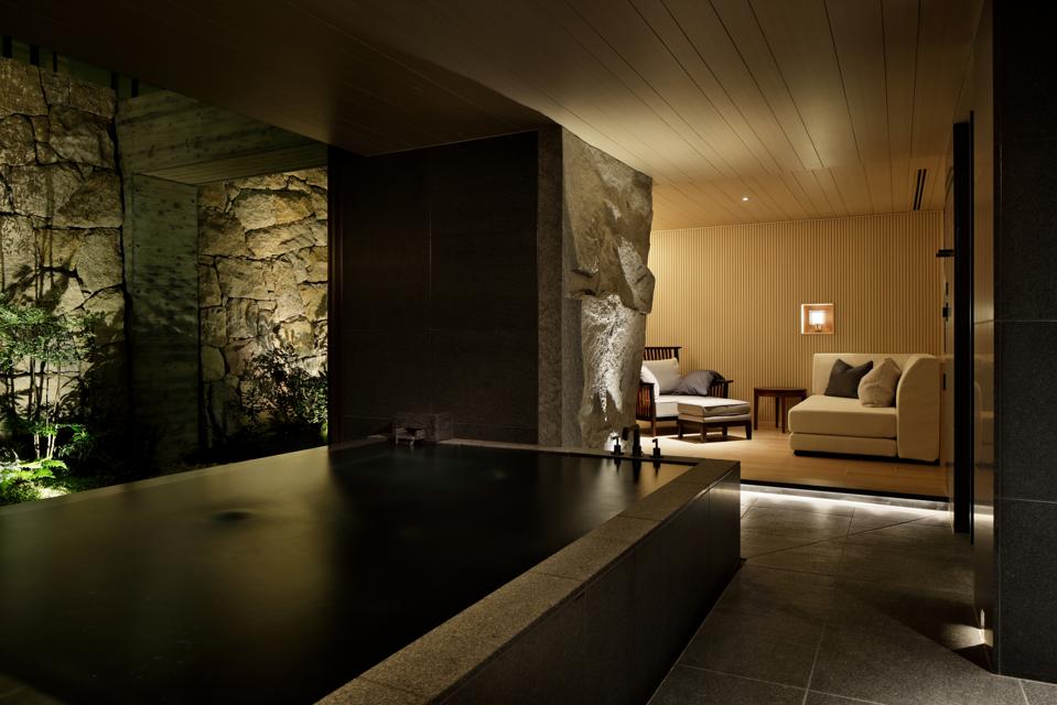 A small rectangular pool surrounded by stone walls