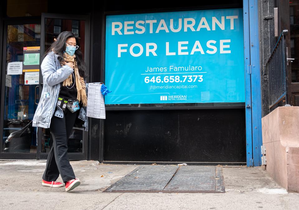 A person walks by a sign that reads, ″restaurant for lease″ outside a restaurant in Hell's Kitchen (Photo by Noam Galai/Getty Images)