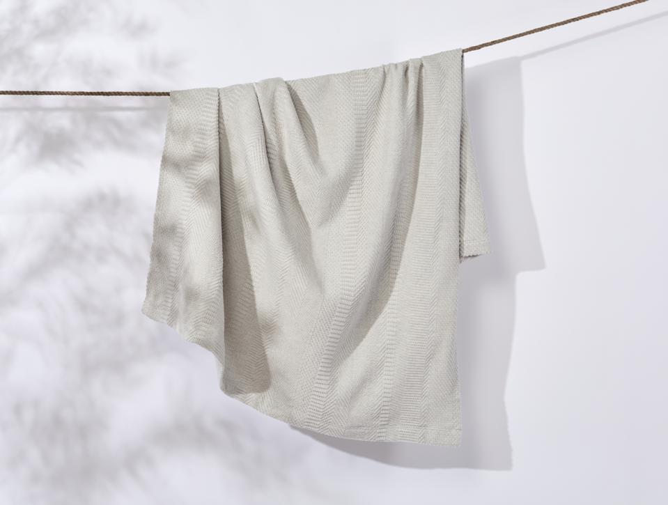 A recycled blanket hanging from a clothesline.