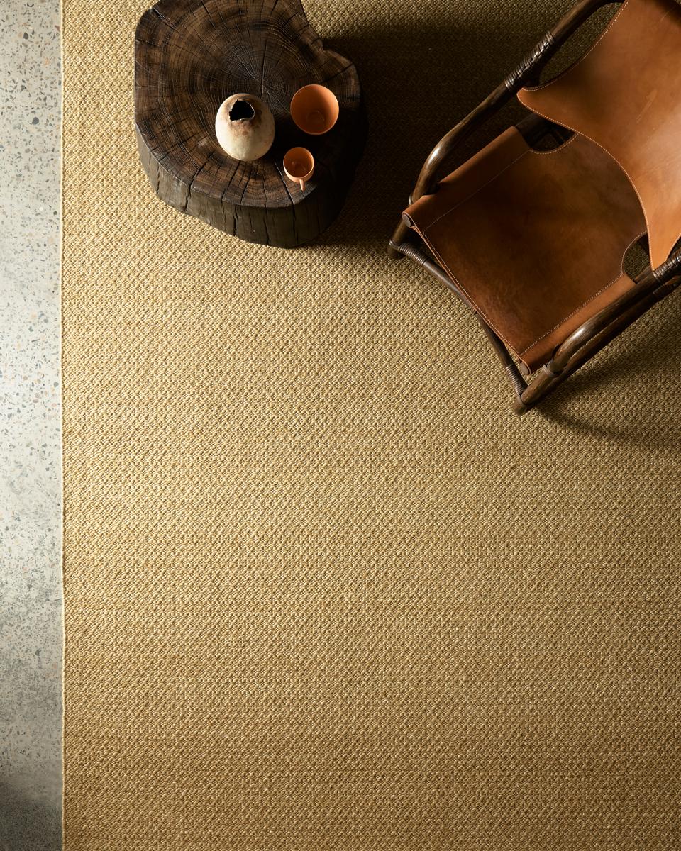 Aerial shot of a yellow-hued natural rug.