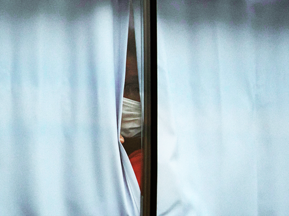 Man stays at home in quarantine looking out window