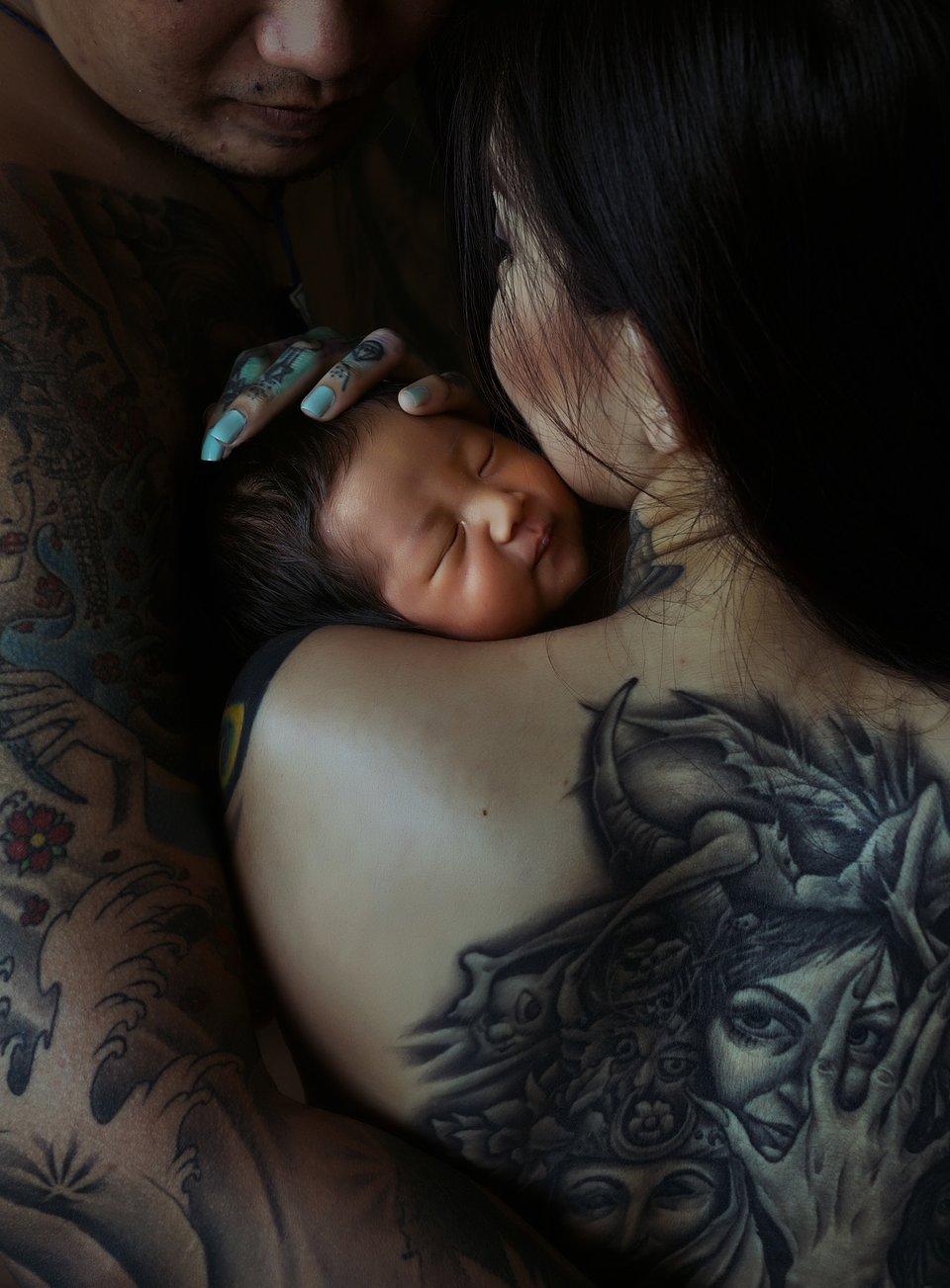 A tattooed model with her new baby.