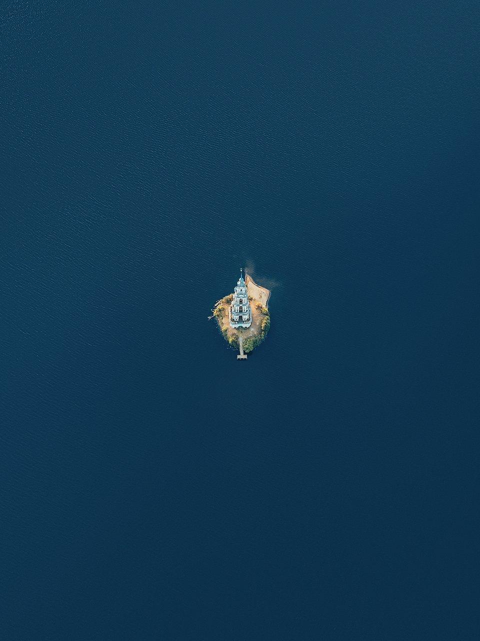 Saint Nicholas Cathedral tower surrounded by water, Kalyazin, Russia from the air.