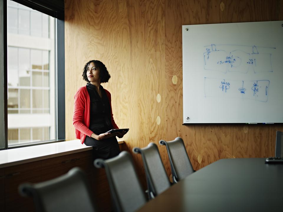 Businesswoman sitting near windows in office