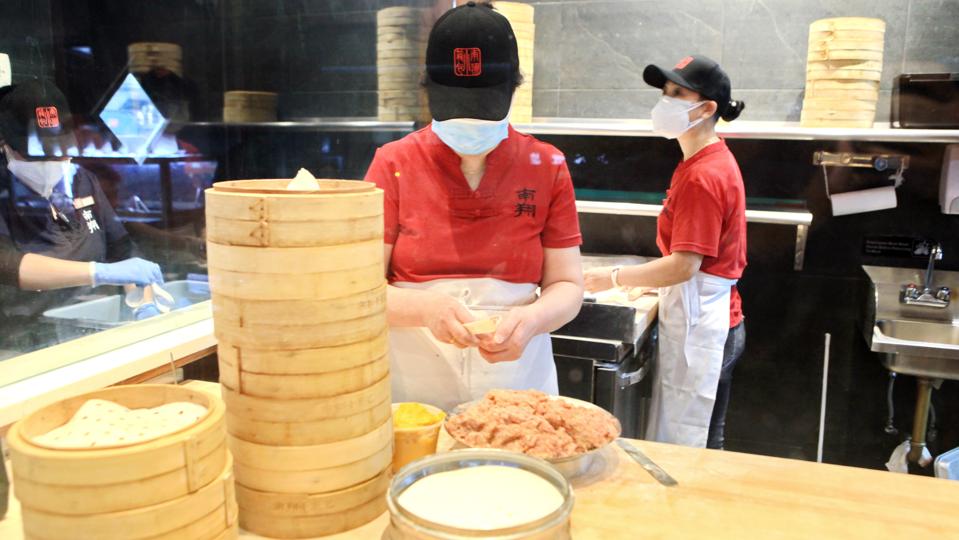 Restaurant workers in the kitchen at Nan Xiang Xiao Long Bao