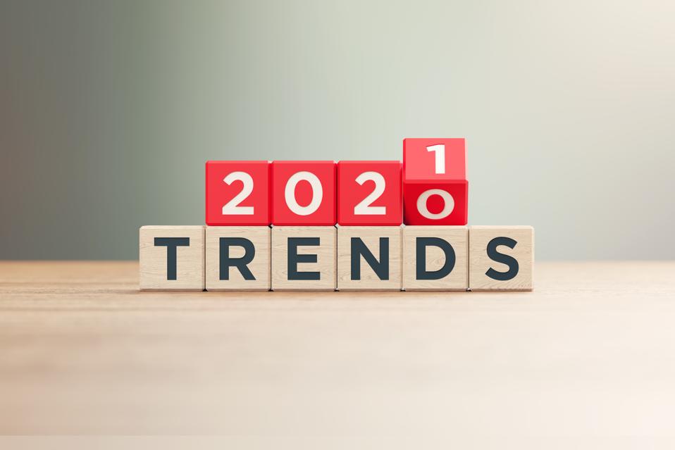 ″2020″ and ″2021 Trends″ Written Red Wood Blocks Sitting on Wood Surface