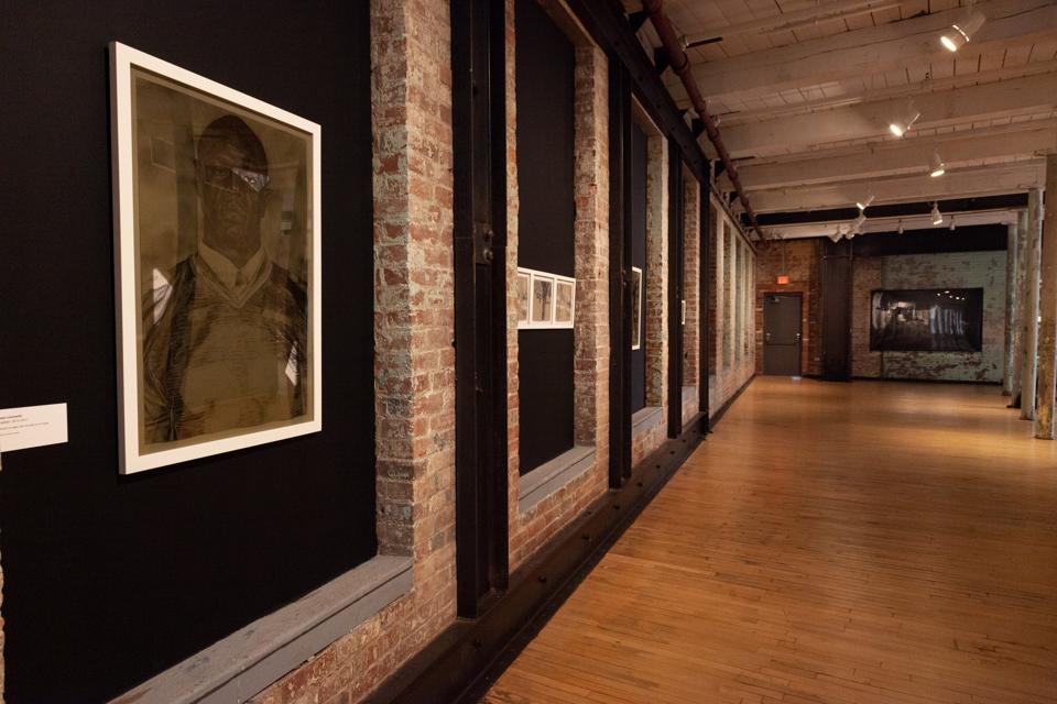 Shaun Leonardo, 'Jonathan,' 2014-2017. Charcoal on paper, with mirrored tint on frame, 30 x 20 5/8 in. As installed in the exhibition, ″The Breath of Empty Space,″ at the Massachusetts Museum of Contemporary Art.