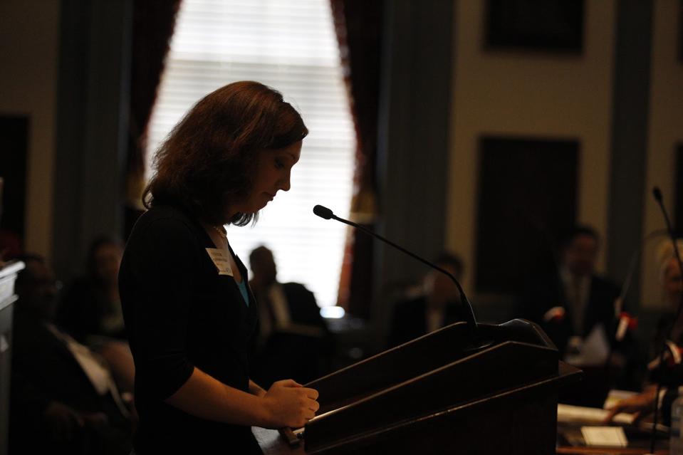 A woman at a podium in the Delaware State Senate.