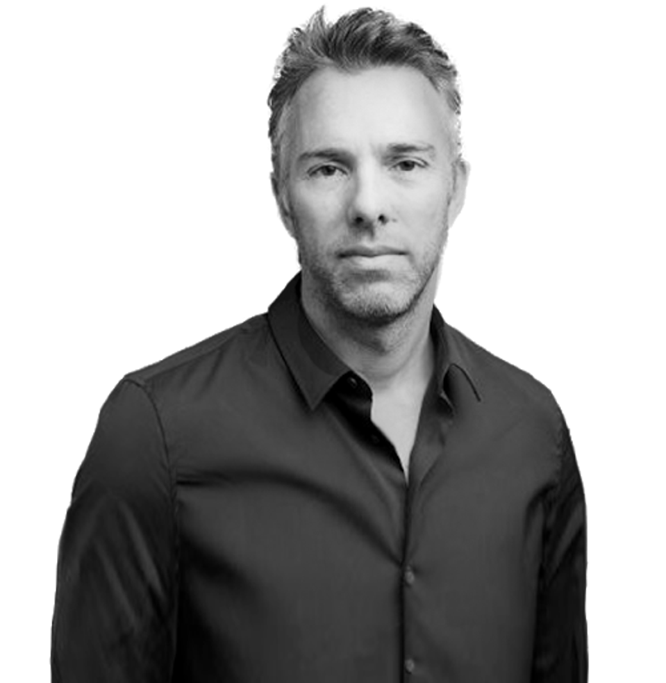 Black and white photo of European white man looking into camera, back button-up shirt