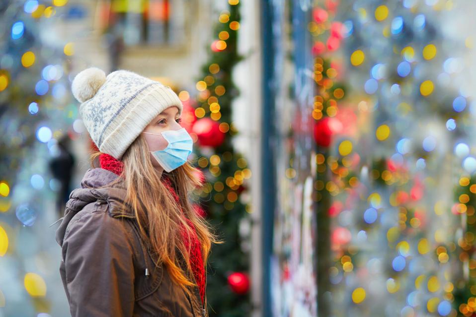 Girl wearing face mask on a Parisian street or at Christmas market