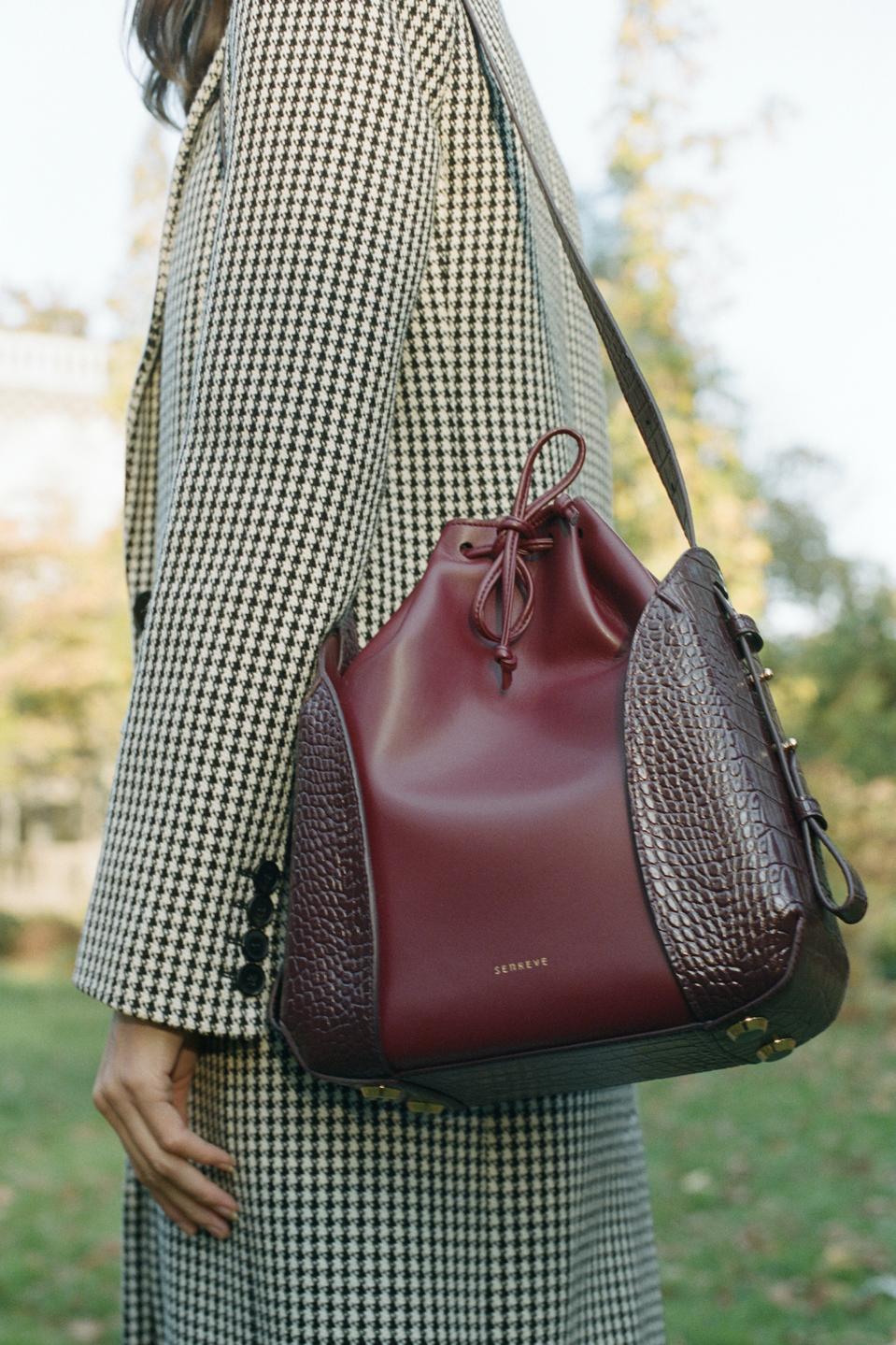 The Fiore Bucket Bag made with Amica Misto vegan leather is available in Night, Currant, Walnut, and Fern.