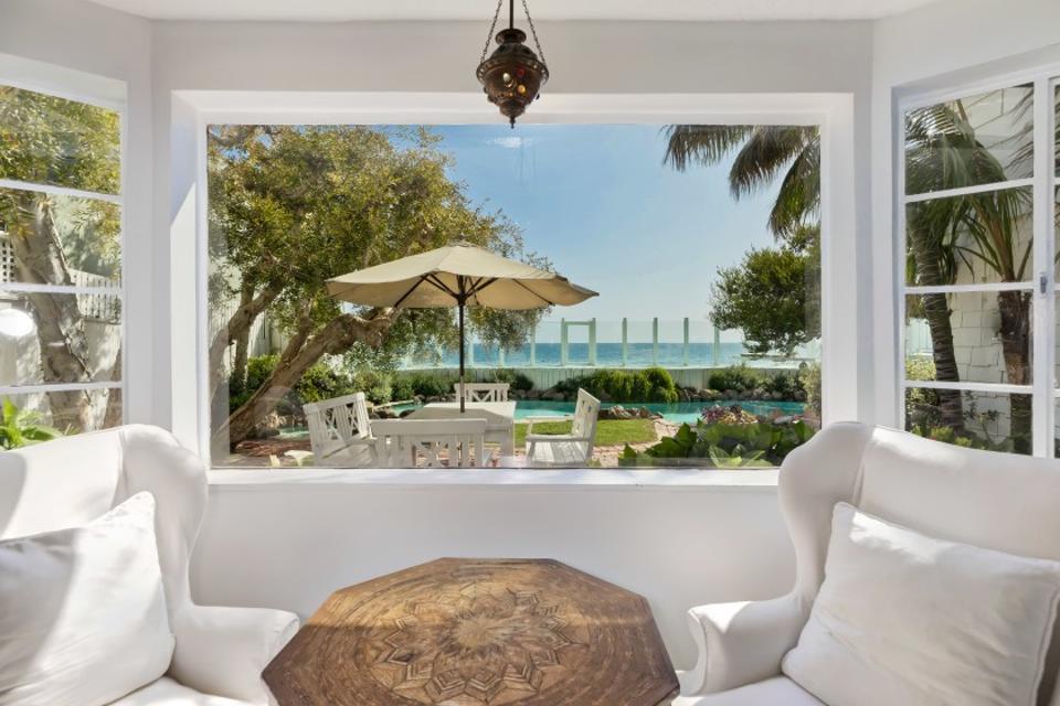 A living room window looking out towards a patio.