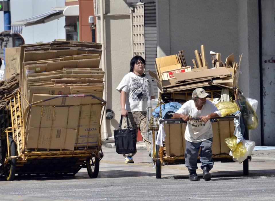 A man pulls a cart transporting cardboard, to sell to a recycling plant, in Tokyo on August 30, 2011. The Japanese economy required a major turnaround following the banking crisis of 2008 and Eurozone crisis of 2011.