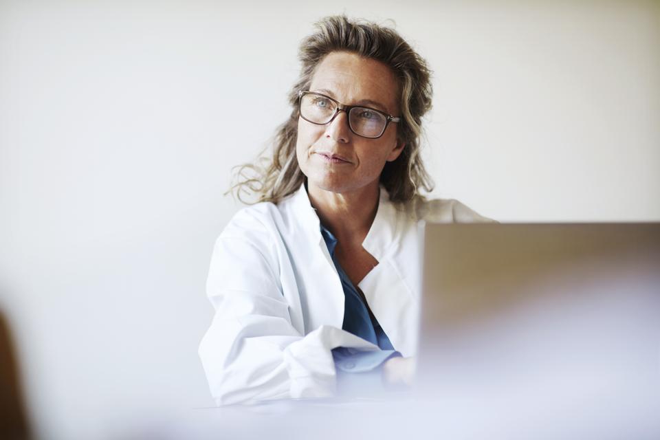 Female doctor using laptop