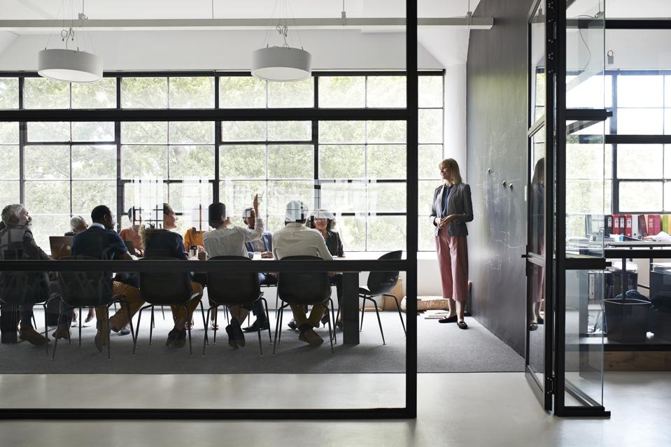 Businesswoman with colleagues in board room