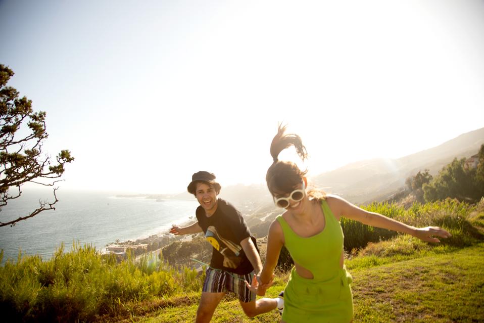 David Dobrik and lady friend running on cliffs overlooking the sea. #DavidsPerfume