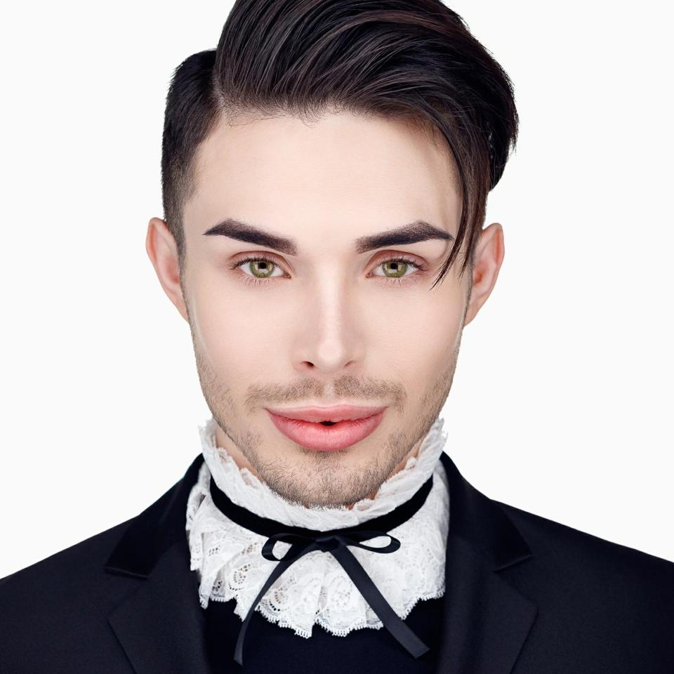 Brandan Rader posing in an androgynous outfit.