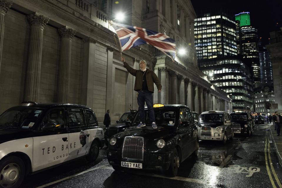 John McDonnell, taxi driver waiving an UK flag on top of a...