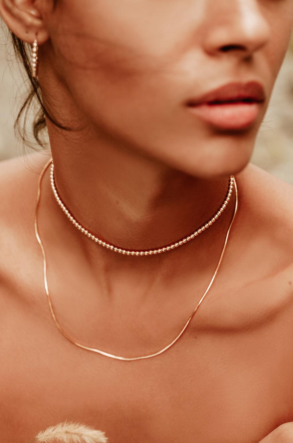 The lightweight Alexa Leigh Mini Snake Necklace is 18k gold filled and can be worn separately or layered to add the perfect touch to any outfit.