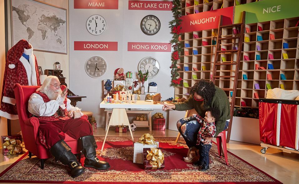 A boy greeting Santa Claus.