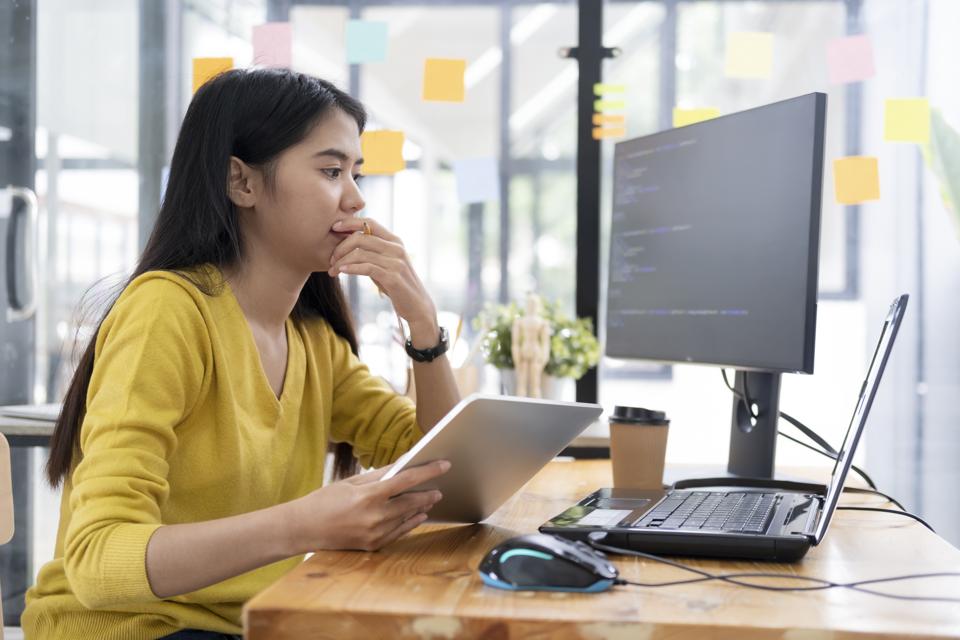 Young woman studying coding online