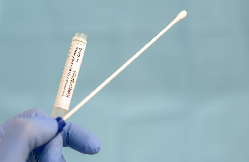 Cotton swab and test tube for Coronavirus test (COVID-19)), macro image of medical equipment in hands of healthcare professional