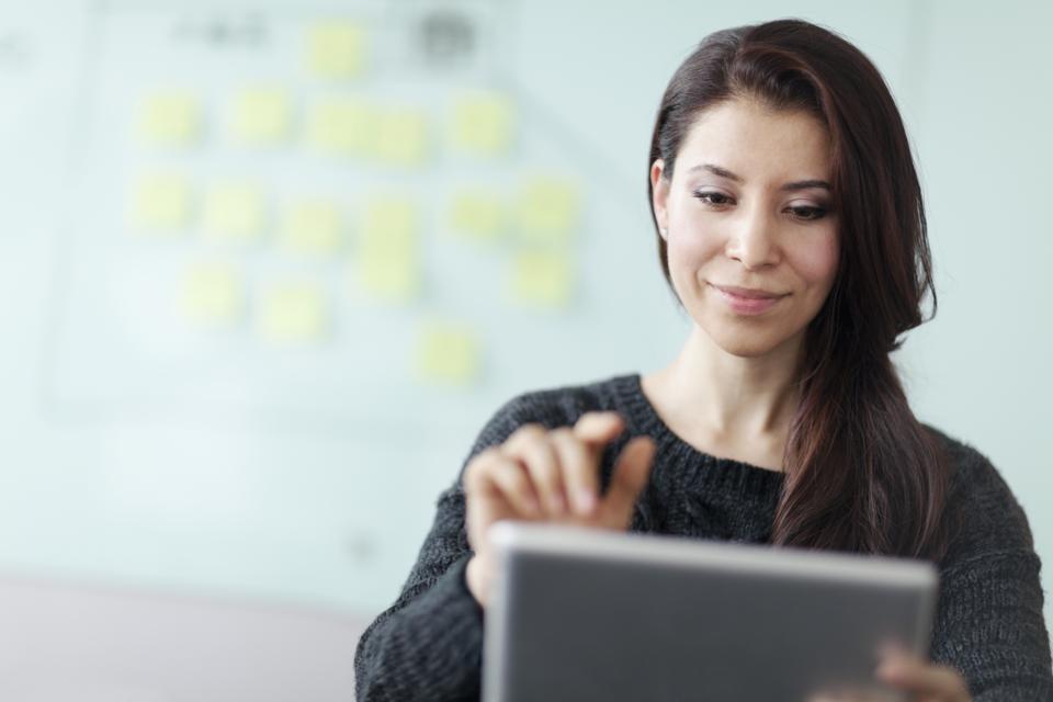 Woman working on tablet computer in studio office