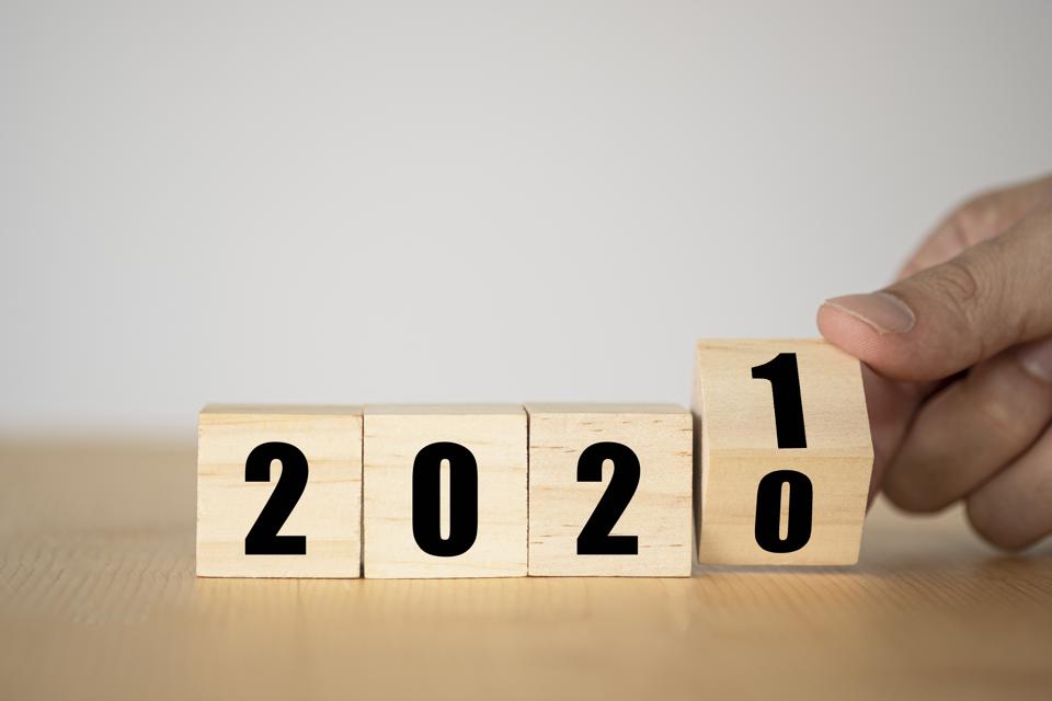Hand flipping wooden blocks for change year 2020 to 2021.